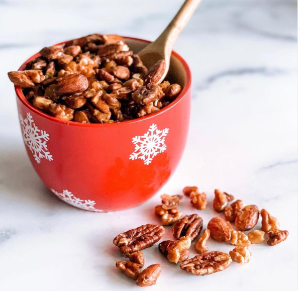 A christmas bowl filled with homemade candied nuts.