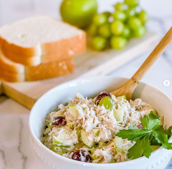 A bowl of prepared chicken salad.