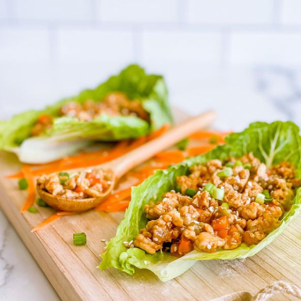 Long lettuce leaves filled with turkey, veggies, and sauce.